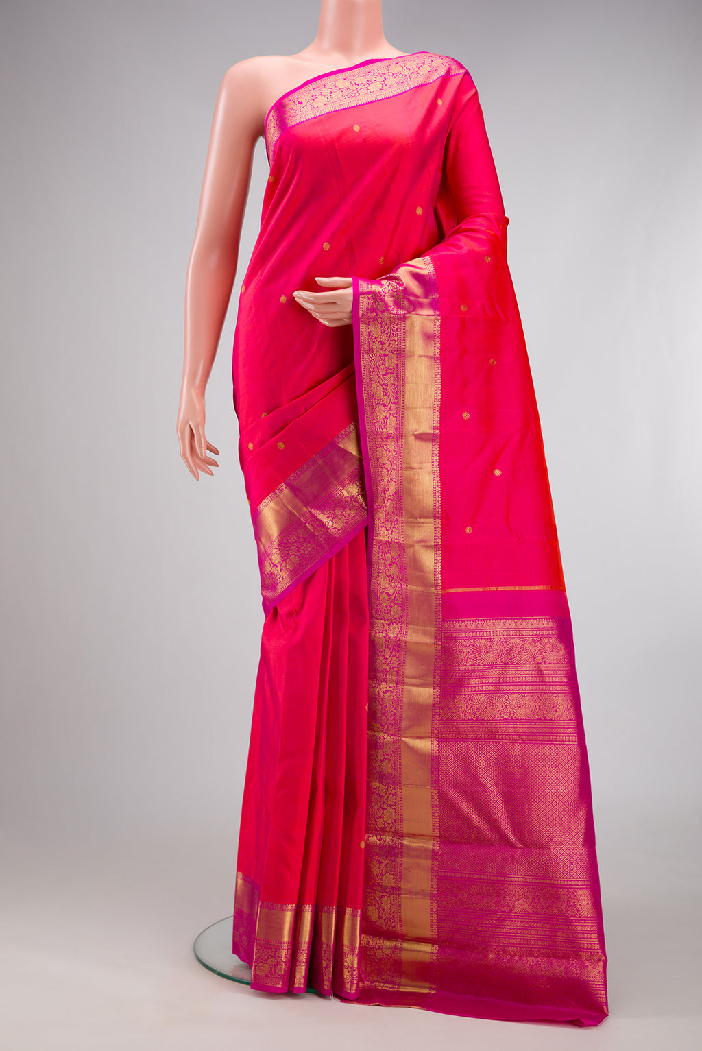 Pink Kanjivaram Silk Saree with Zari Butta on the body and Zari Border.  displayed on a mannequin