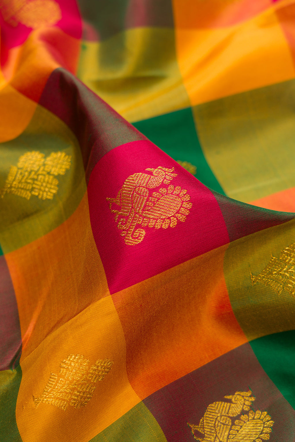 Close up of Multi Color Kanchipuram Silk Saree with Checked design on the body and Zari Border.  displaying folds