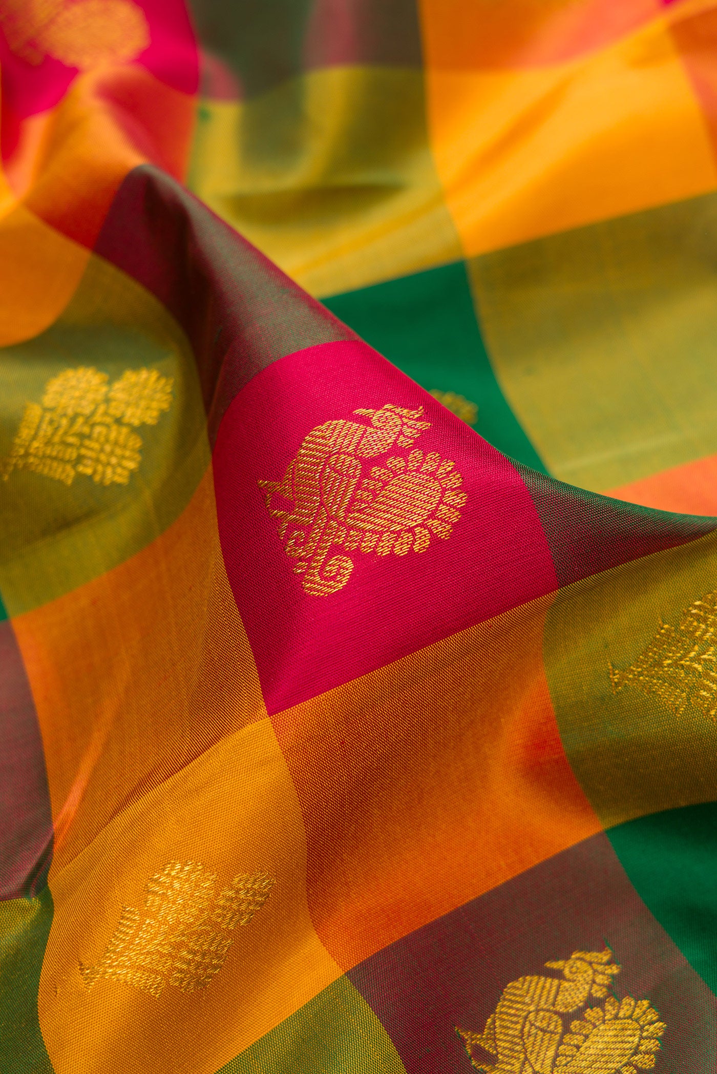 Close up of Multi Color Kanchipuram Silk Saree with Checked design on the body and Zari Border.  displaying folds