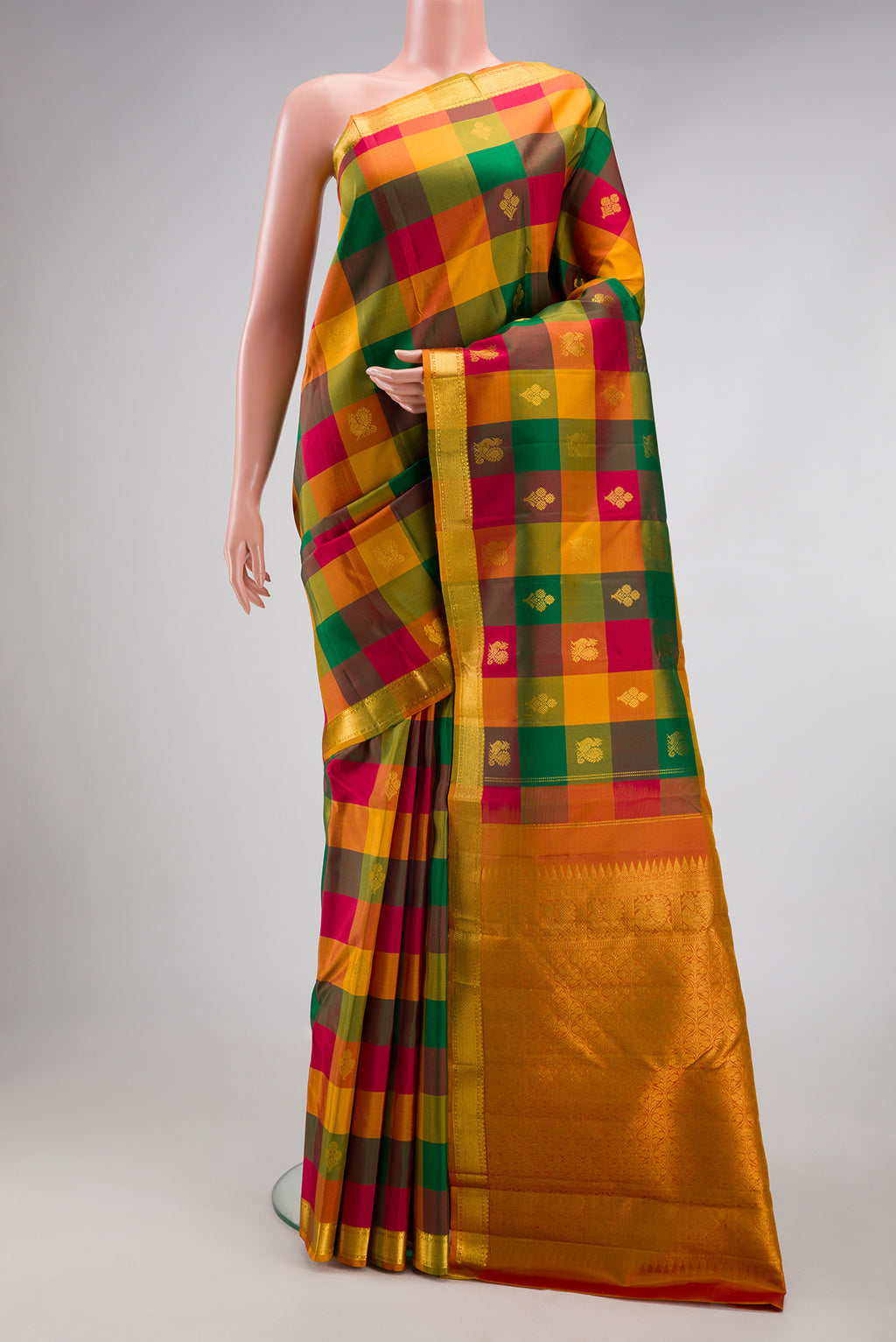 Multi Color Kanchipuram Silk Saree with Checked design on the body and Zari Border.  displayed on a mannequin