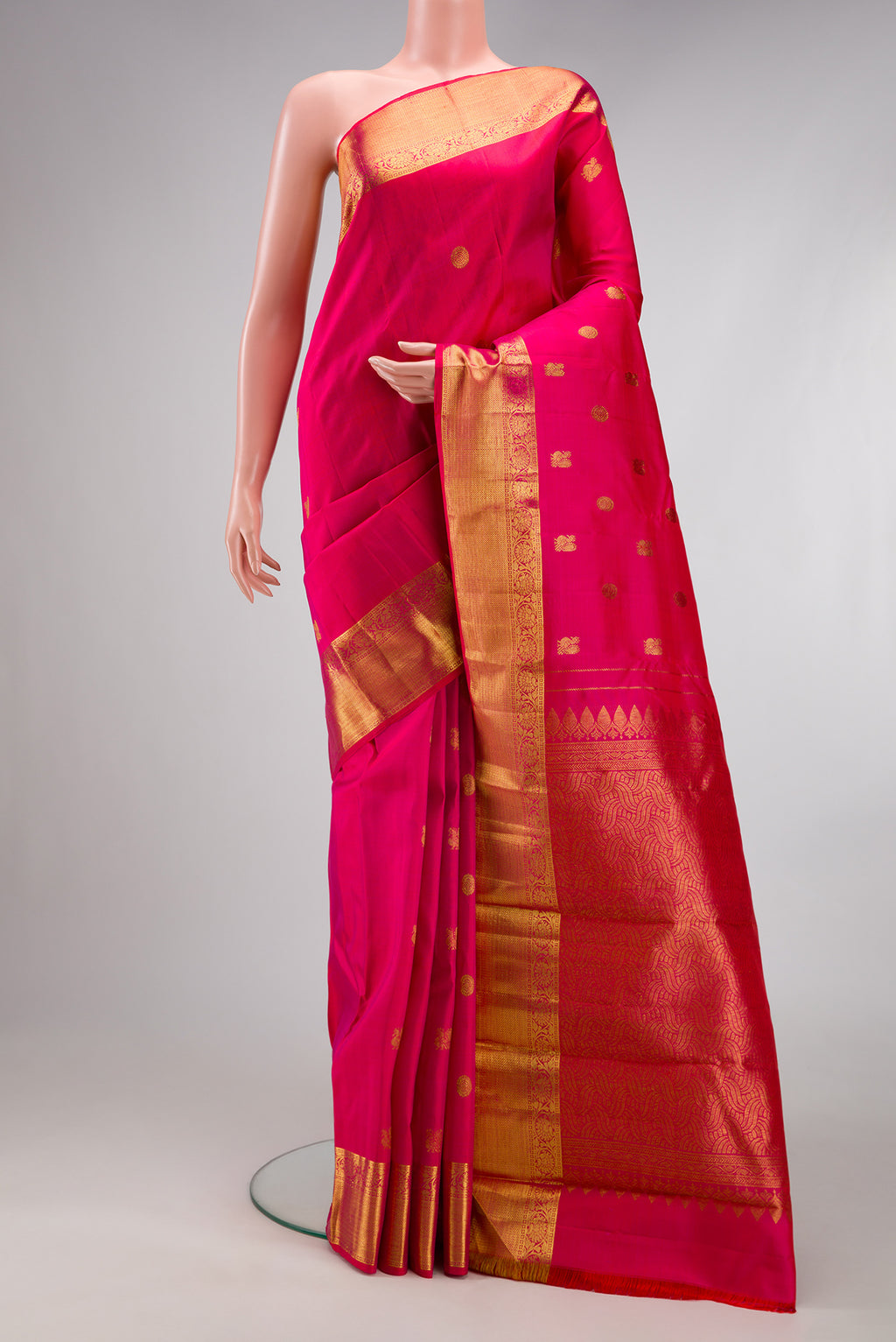 Dark Pink Kanjivaram Silk Saree with Zari Butta on the body and Zari Border.  displayed on a mannequin