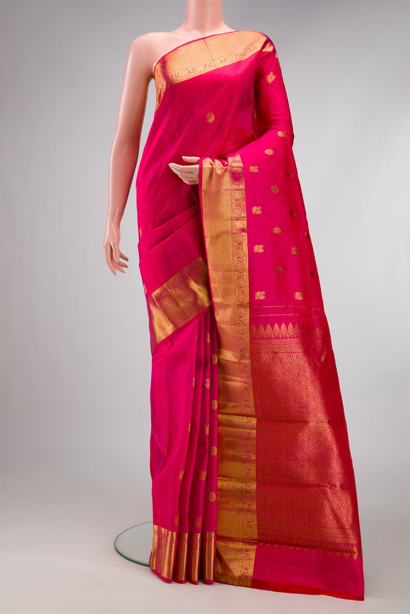 Dark Pink Kanjivaram Silk Saree with Zari Butta on the body and Zari Border.  displayed on a mannequin