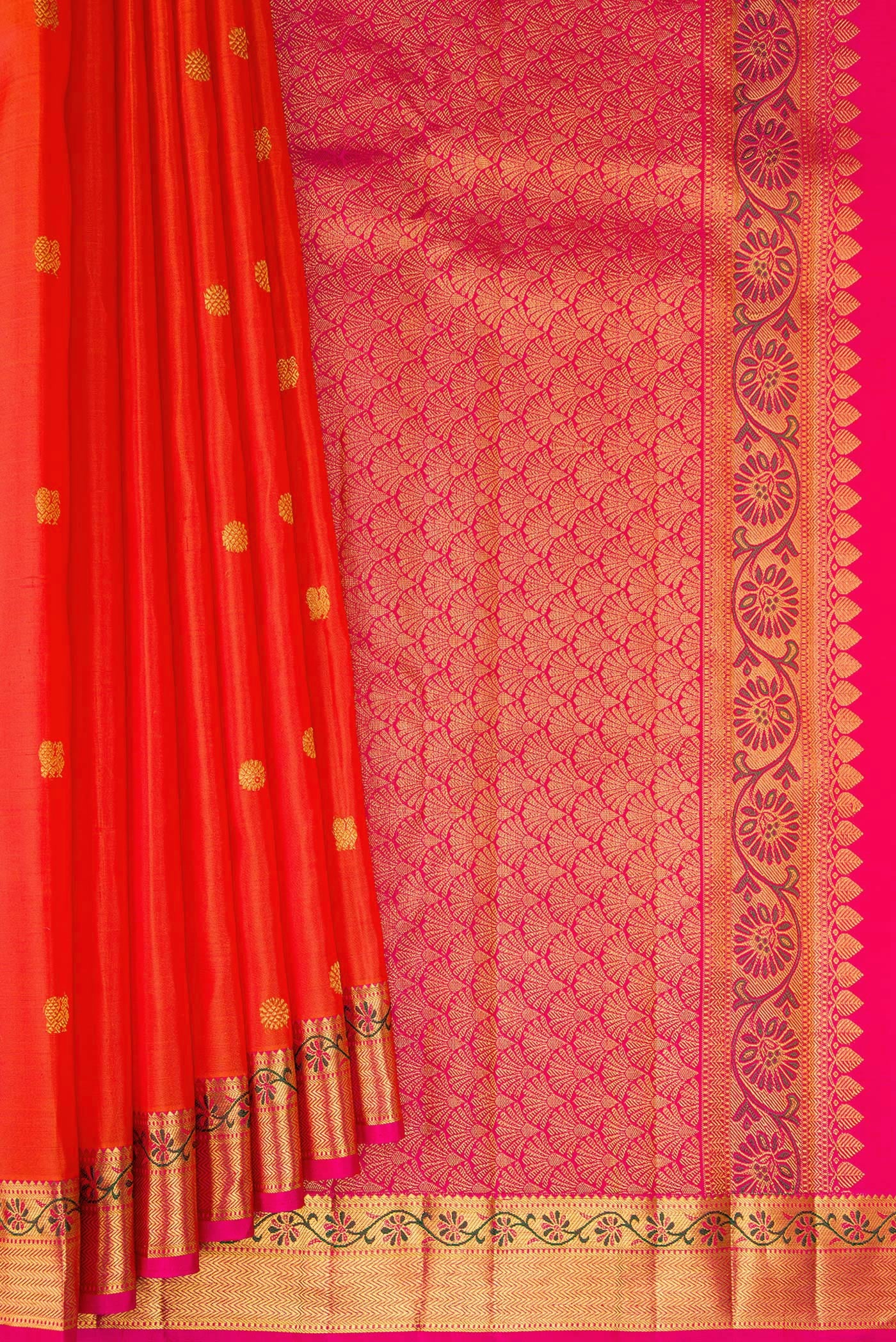 Pleats and pallu of Orange Kanjivaram Silk Saree with Zari Butta on the body and Zari And Thread Border. 