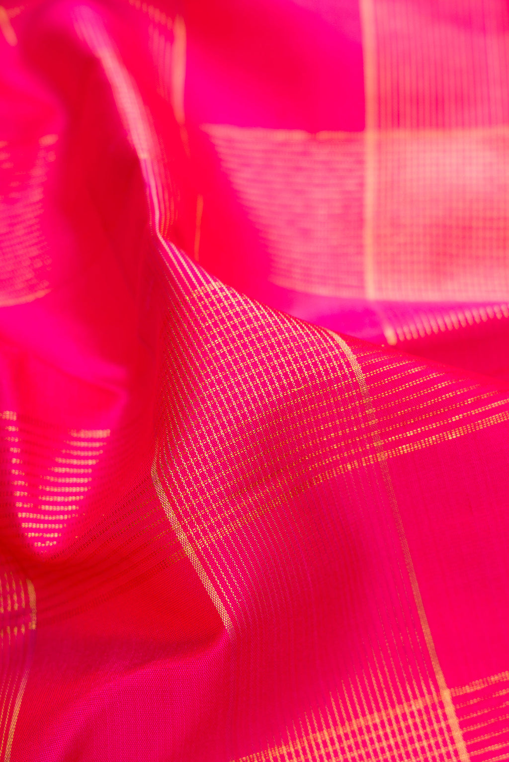 Close up of Pink Kanjivaram Silk Saree with Checked design on the body and Zari Border.  displaying folds