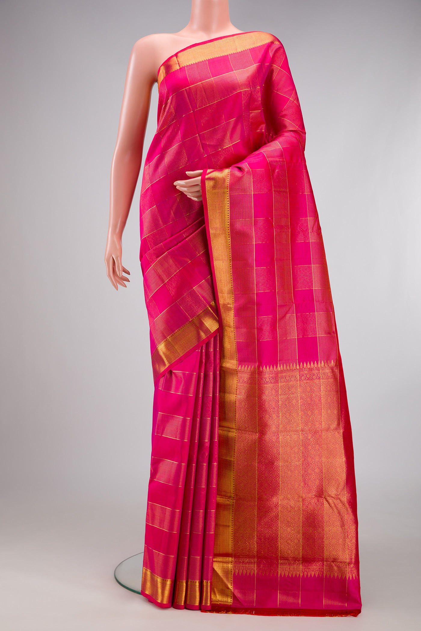 Pink Kanjivaram Silk Saree with Checked design on the body and Zari Border.  displayed on a mannequin
