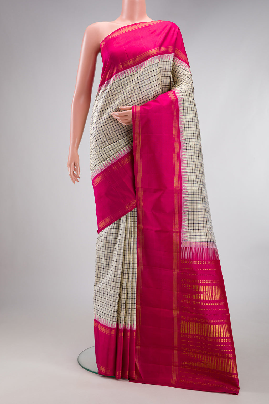 Beige Kanjivaram Silk Saree with Checked design on the body and Zari Border.  displayed on a mannequin