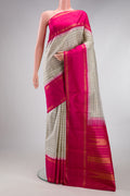 Beige Kanjivaram Silk Saree with Checked design on the body and Zari Border.  displayed on a mannequin