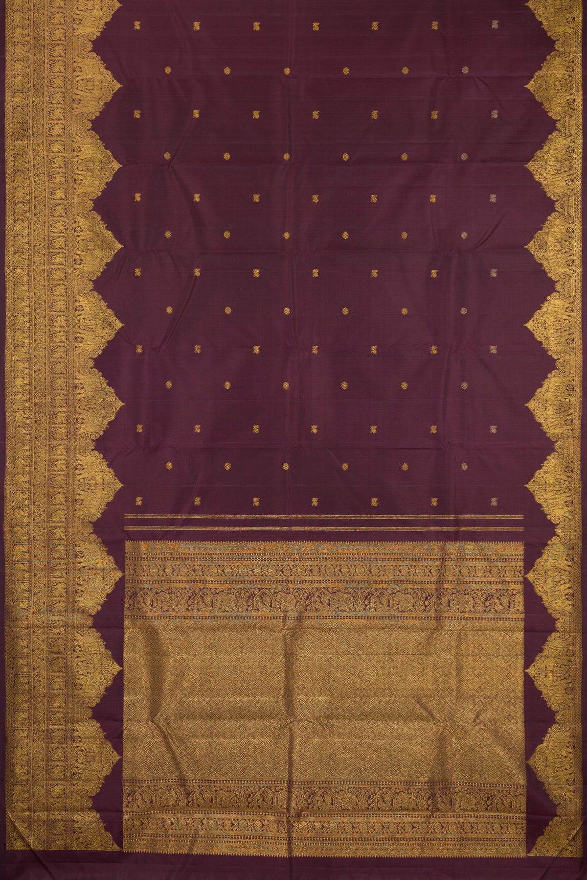 Flat view of Burgundy Kanjivaram Silk Saree with Zari Butta on the body and Fancy Border. 