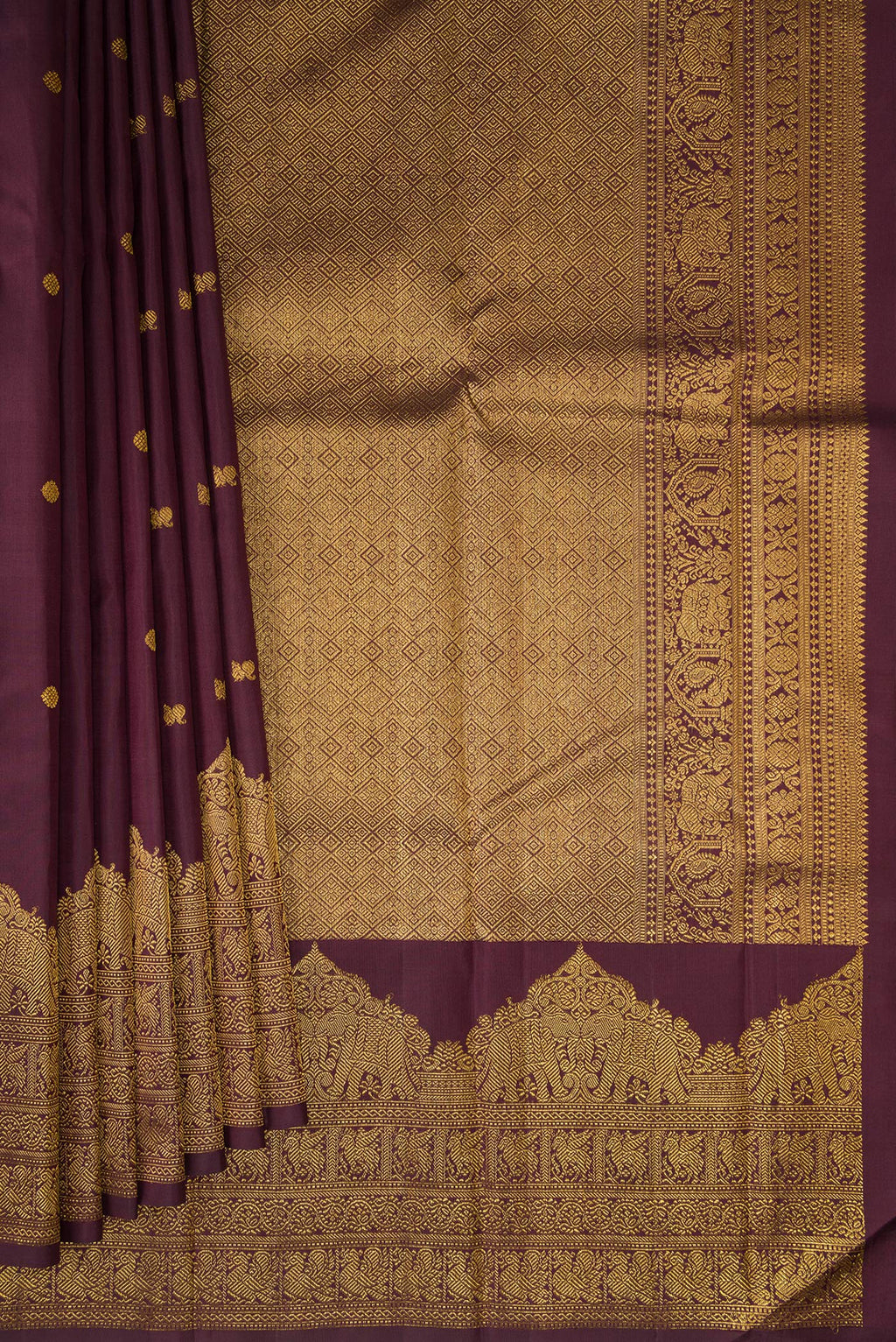 Pleats and pallu of Burgundy Kanjivaram Silk Saree with Zari Butta on the body and Fancy Border. 