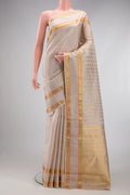 Dark Beige Kanjivaram Silk Saree with Zari Butta on the body and Zari And Thread Border.  displayed on a mannequin
