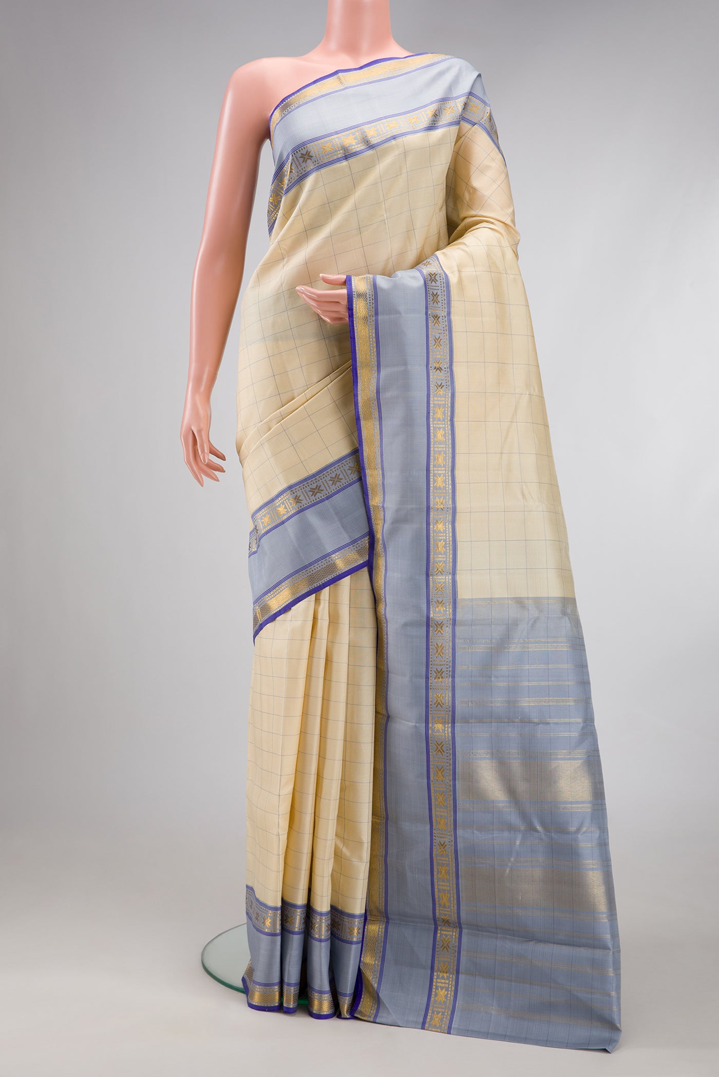 Sandal Kanjivaram Silk Saree with Checked design on the body and Zari Border.  displayed on a mannequin