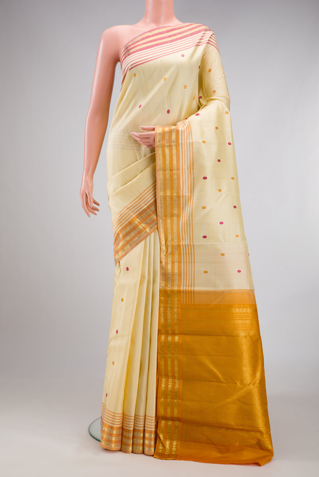 Sandal Kanjivaram Silk Saree with Zari And Thread Butta on the body and Zari Border.  displayed on a mannequin