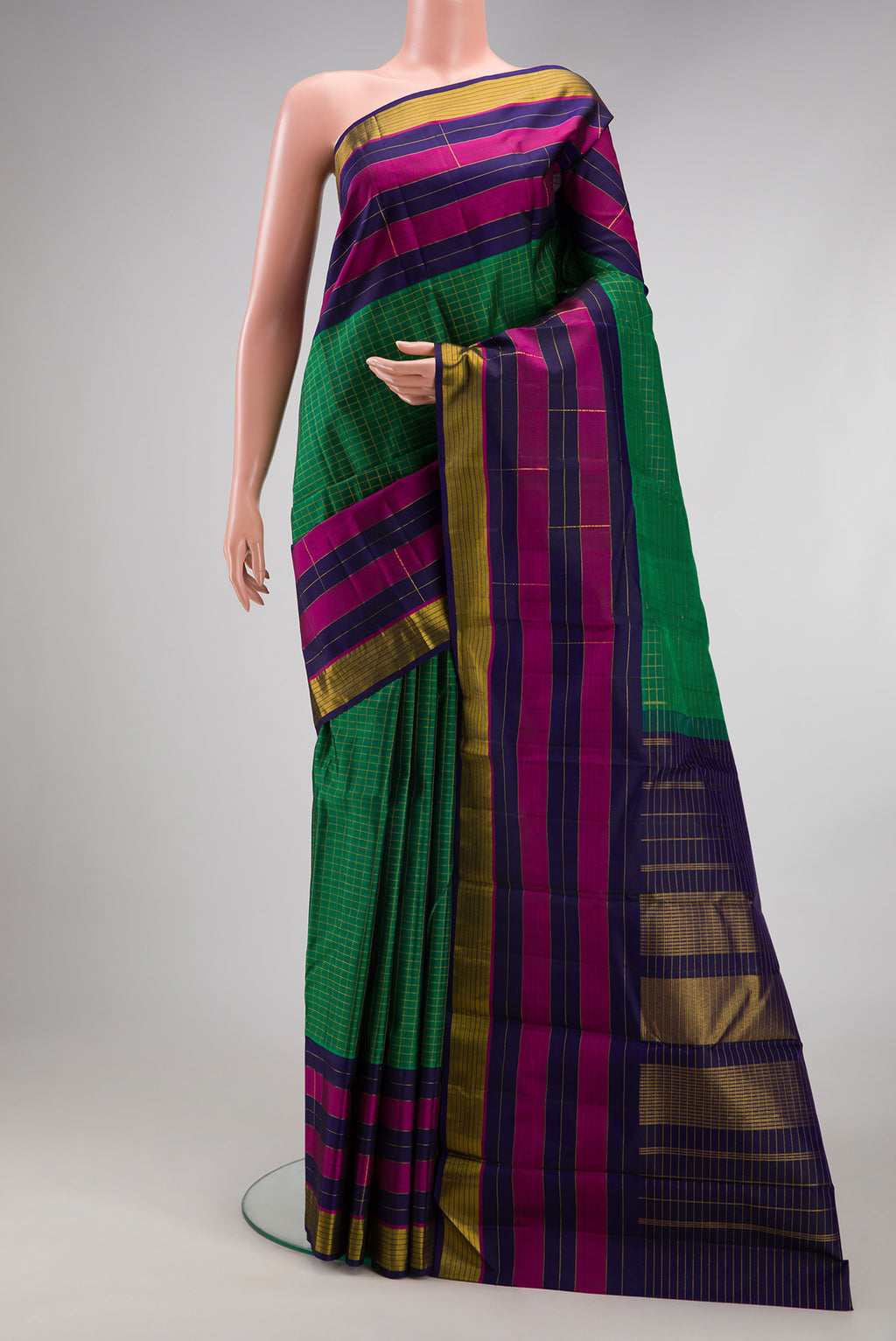 Bottle Green Kanchipuram Silk Saree with Checked design on the body and Fancy Border.  displayed on a mannequin