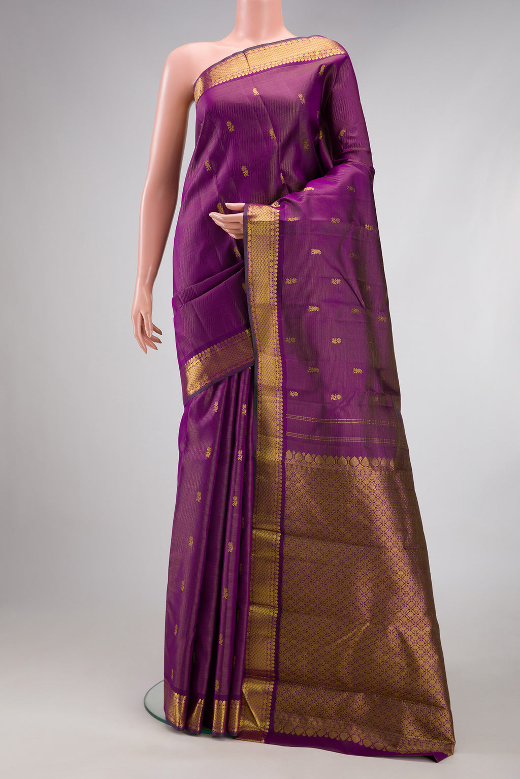 Purple Kanjivaram Silk Saree with Zari Butta on the body and Zari Border.  displayed on a mannequin