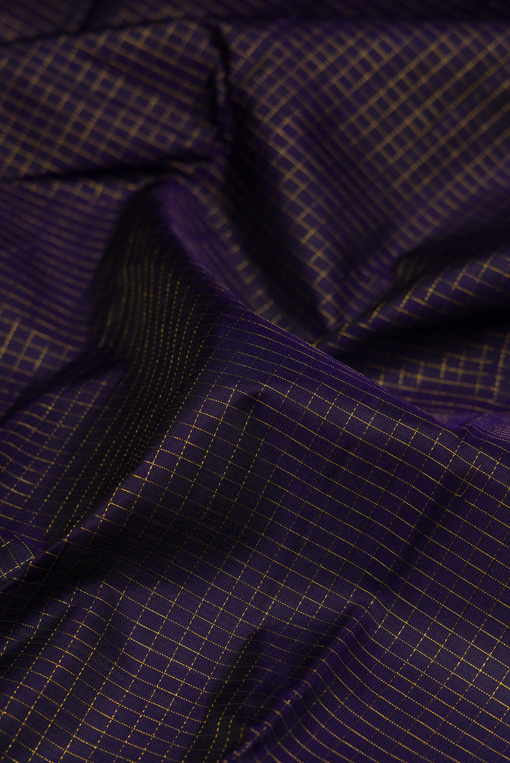 Close up of Navy Blue Kanjivaram Silk Saree with Checked design on the body and Fancy Border.  displaying folds