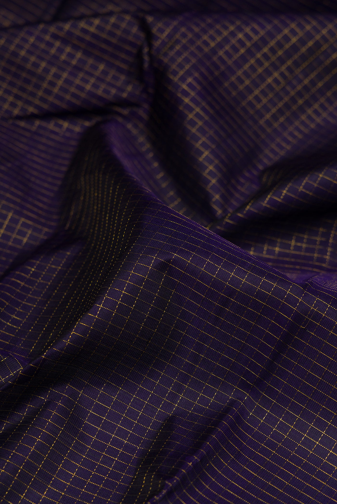 Close up of Navy Blue Kanjivaram Silk Saree with Checked design on the body and Fancy Border.  displaying folds