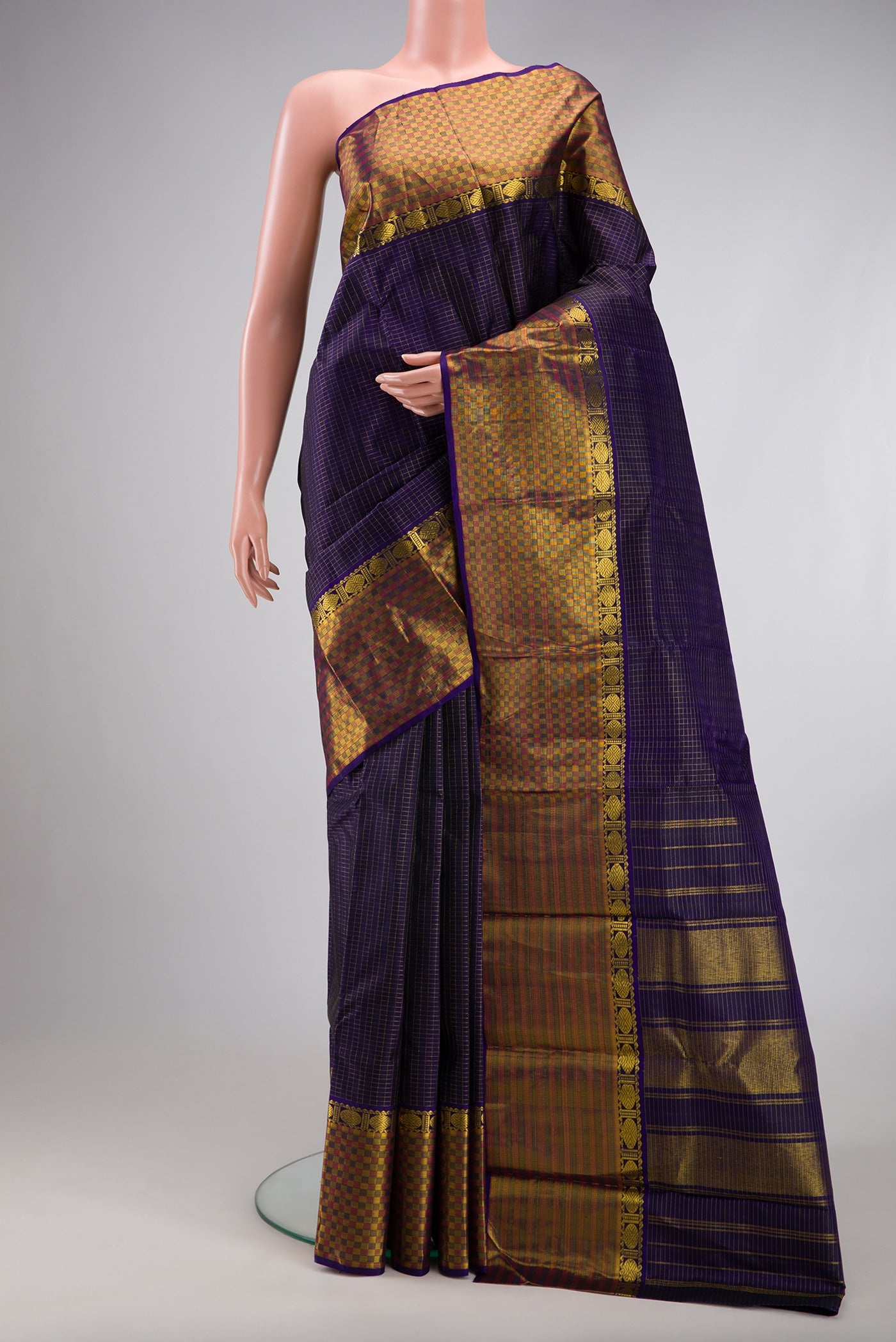 Navy Blue Kanjivaram Silk Saree with Checked design on the body and Fancy Border.  displayed on a mannequin