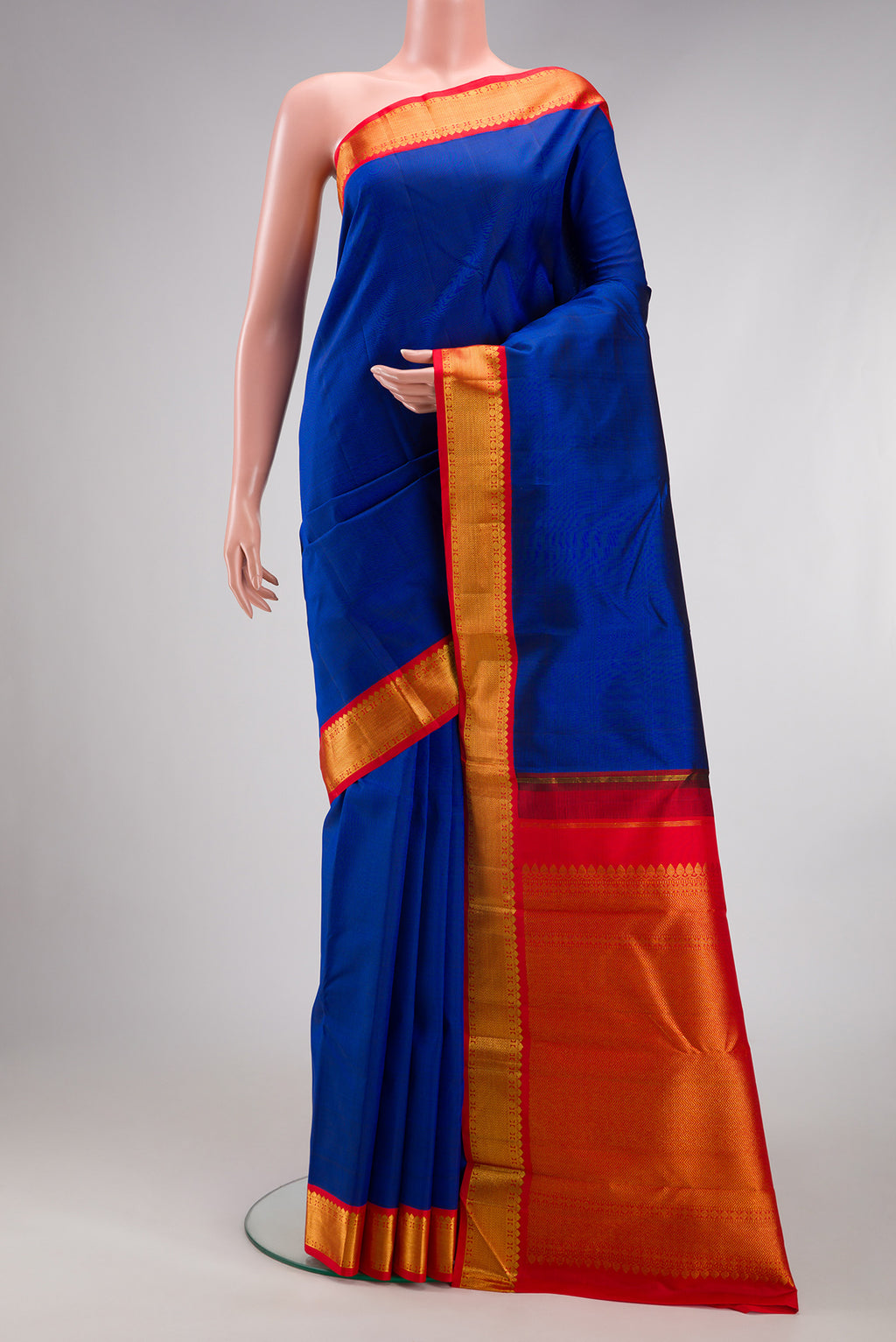 Royal Blue Kanjivaram Silk Saree with Plain Body and Zari Border.  displayed on a mannequin