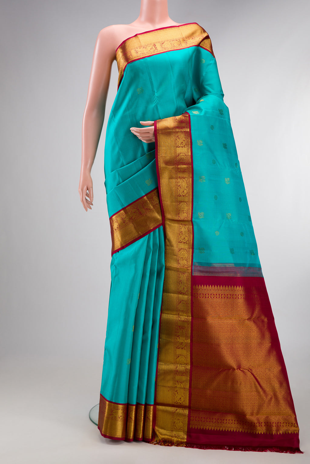 Pure Silk Sky Blue Kanjivaram Saree with Zari Butta on the body and Zari Border.  displayed on a mannequin