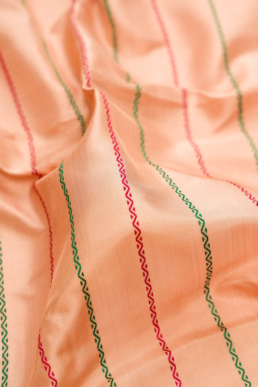 Close up of Beige Kanjivaram Silk Saree with Veldhari on the body and Zari Border.  displaying folds