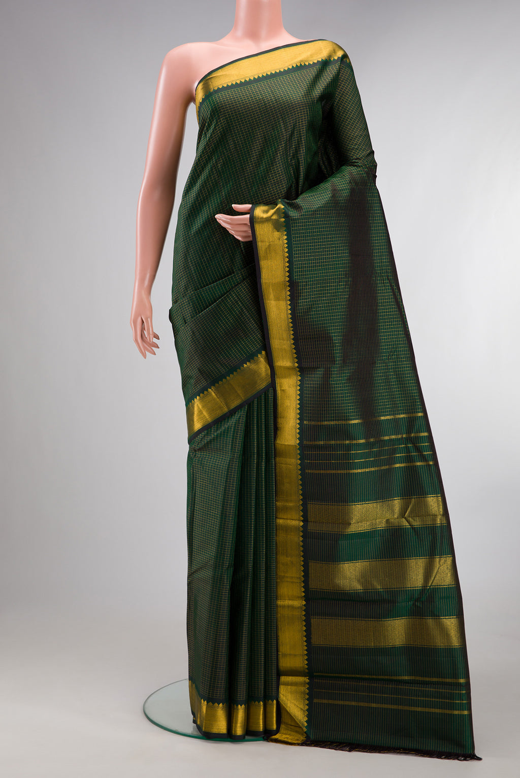Pure Silk Bottle Green Kanchipuram Saree with Checked design on the body and Zari Border.  displayed on a mannequin