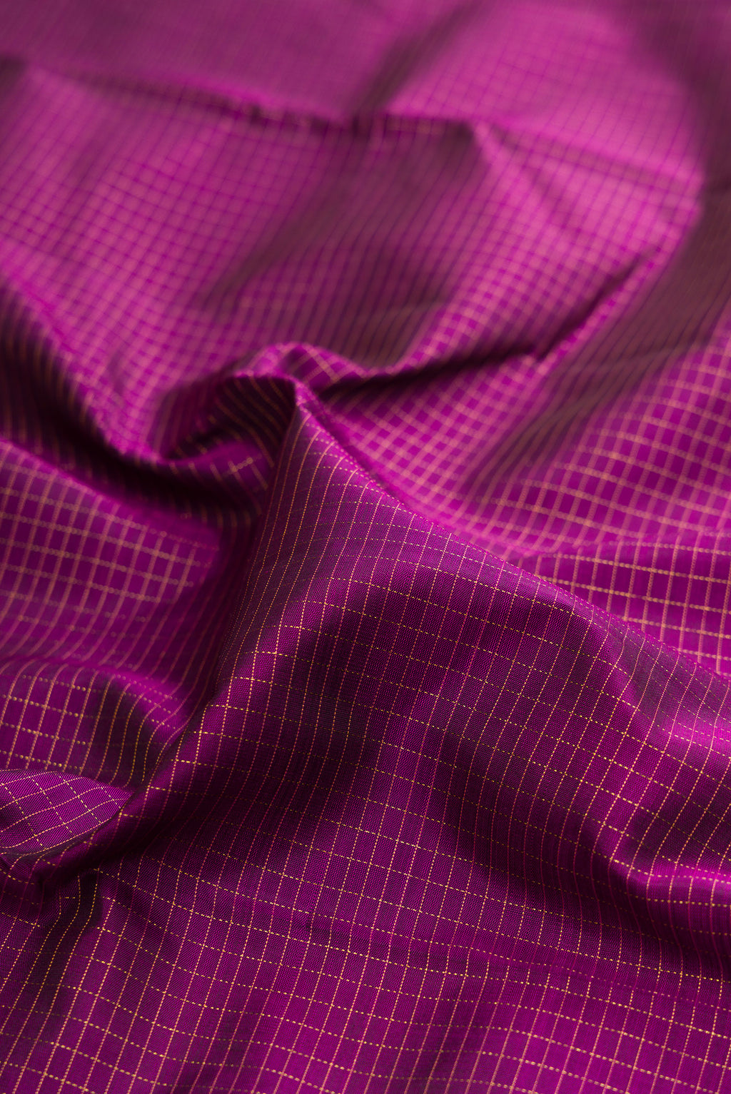 Close up of Purple Kanchipuram Silk Saree with Checked design on the body and Zari Border.  displaying folds