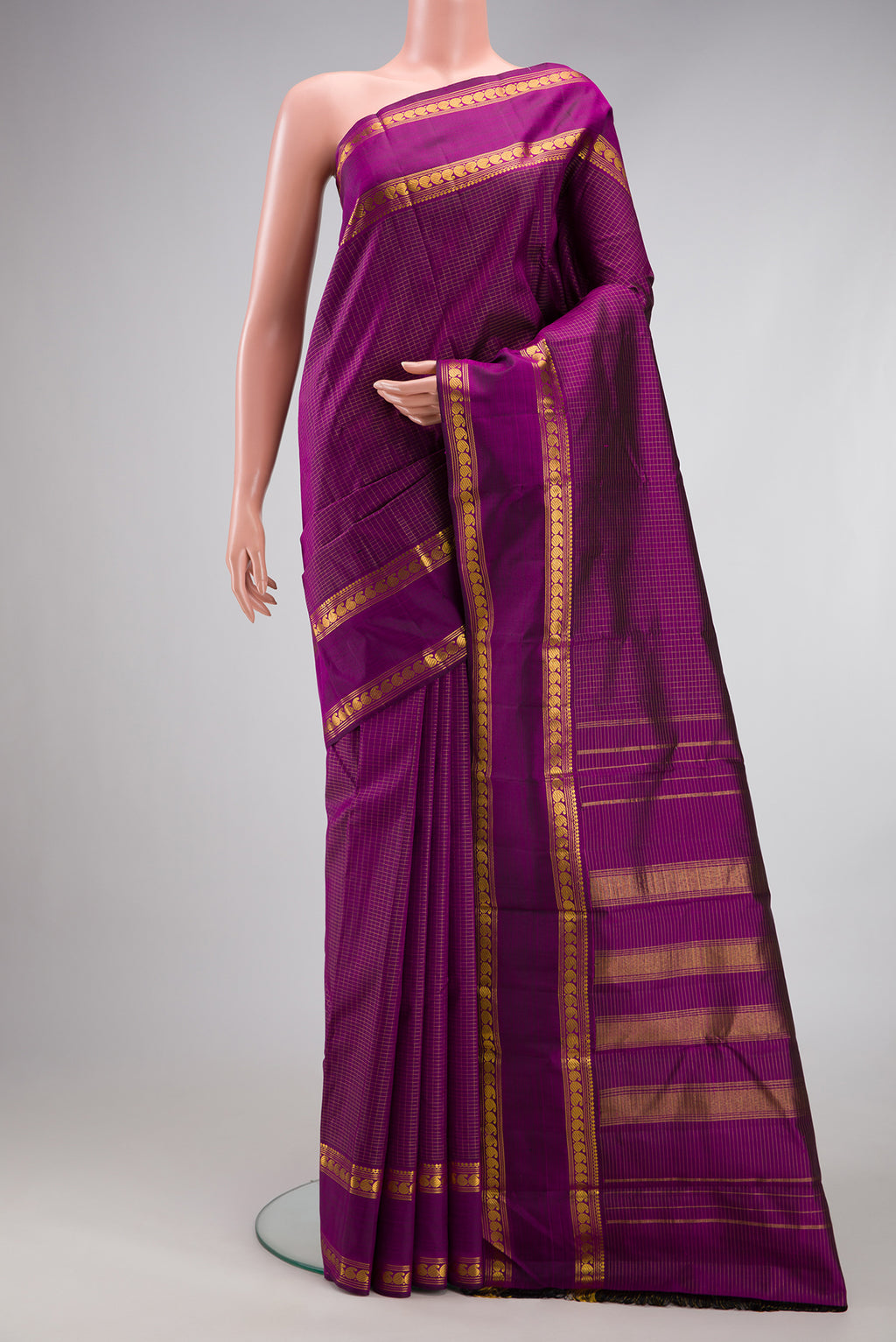 Purple Kanchipuram Silk Saree with Checked design on the body and Zari Border.  displayed on a mannequin