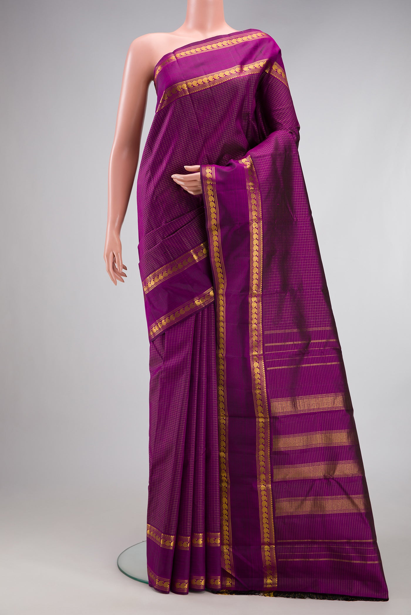 Purple Kanchipuram Silk Saree with Checked design on the body and Zari Border.  displayed on a mannequin