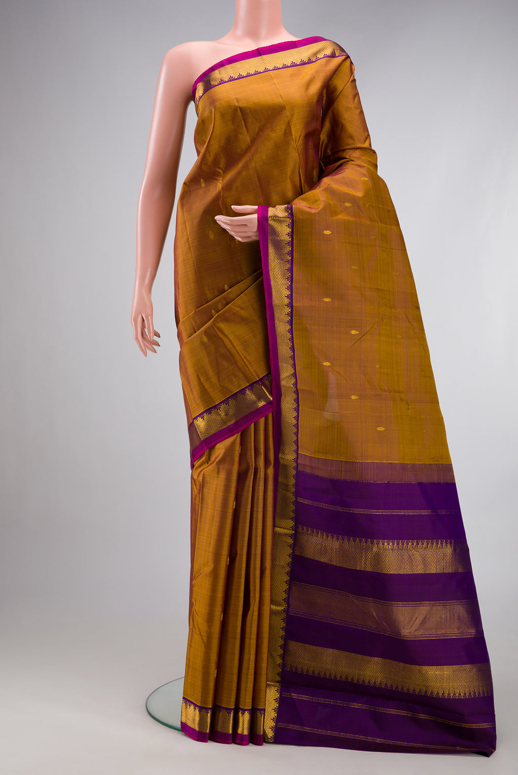 Mehandi Green Dual Tone Kanchipuram Silk Saree with Zari Butta on the body and Zari Border.  displayed on a mannequin