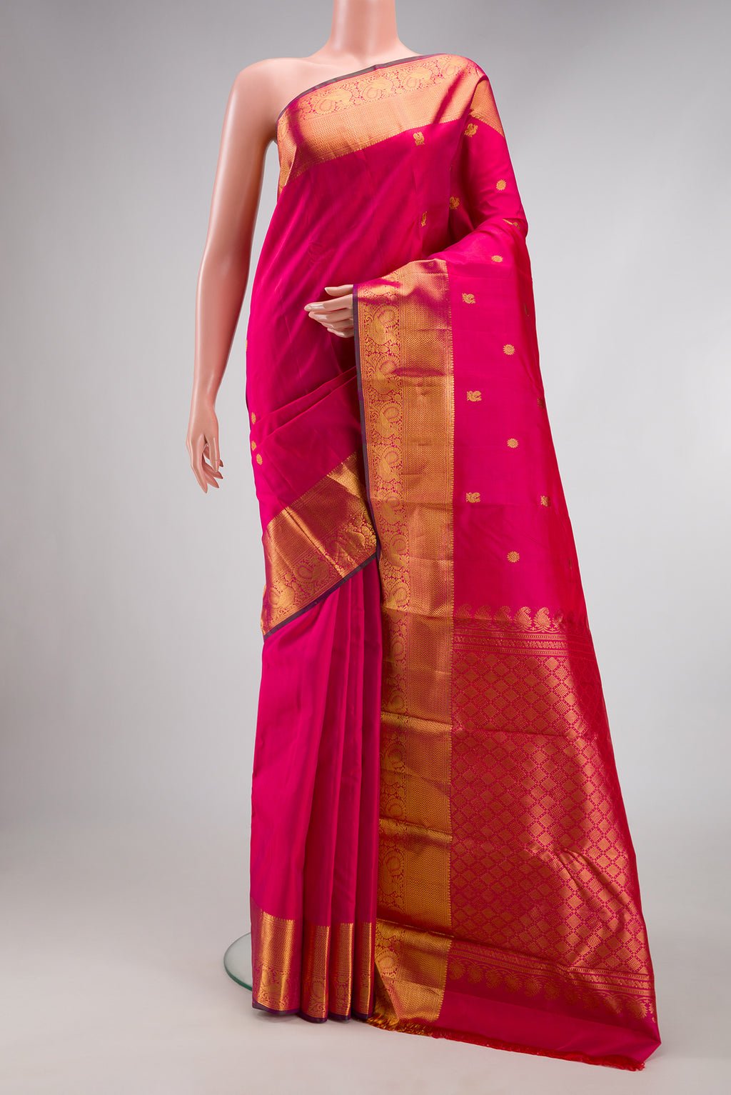 Pink Kanjivaram Silk Saree with Zari Butta on the body and Zari Border.  displayed on a mannequin