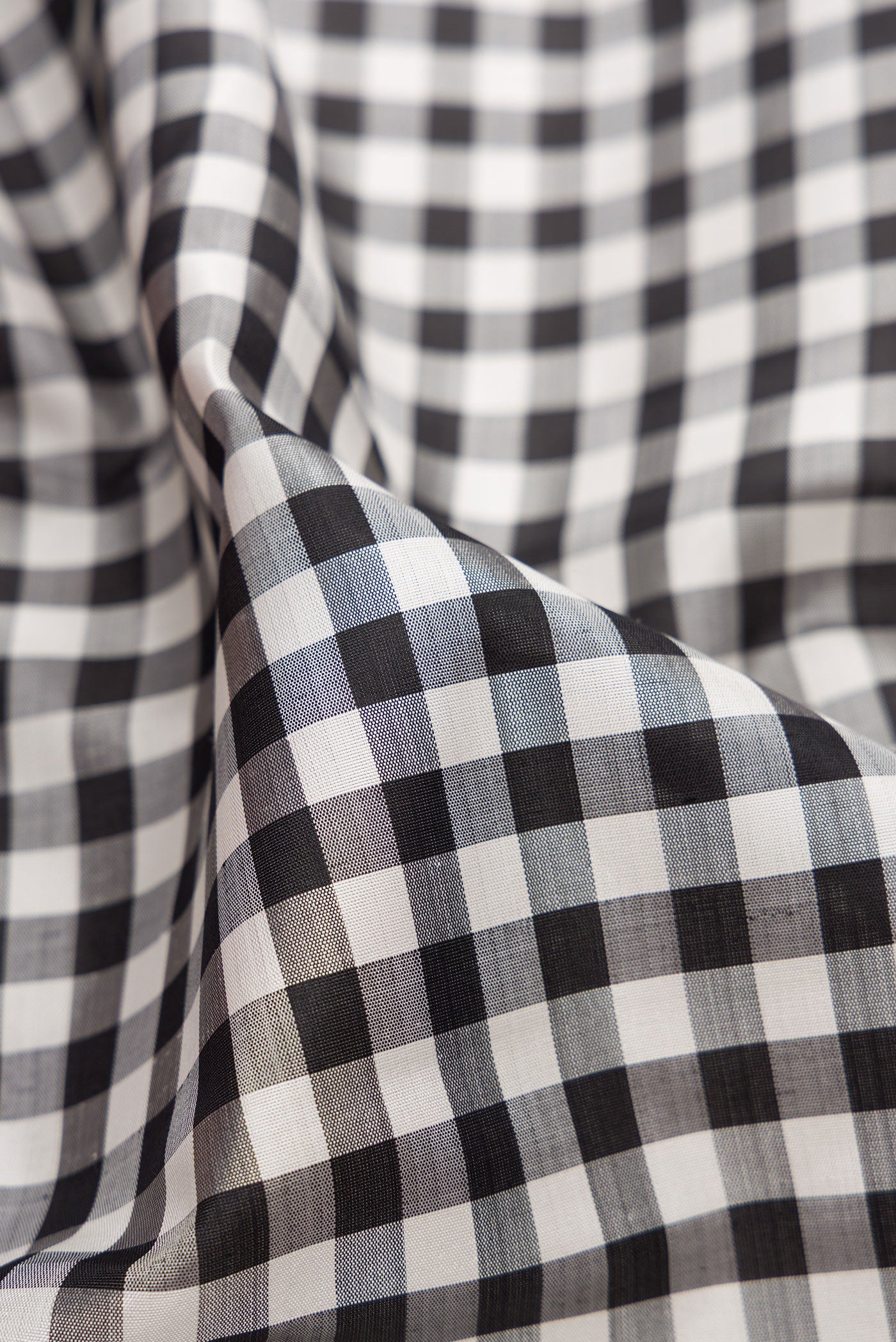 Close up of Multi Color Kanjivaram Silk Saree with Checked design on the body and Zari Border.  displaying folds