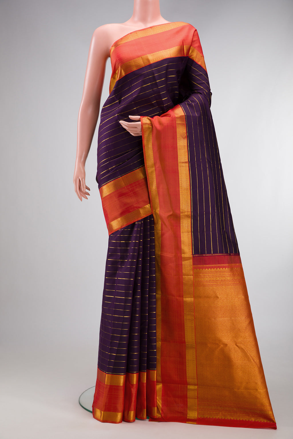 Violet Kanjivaram Silk Saree with Stripes on the body and Zari Border.  displayed on a mannequin