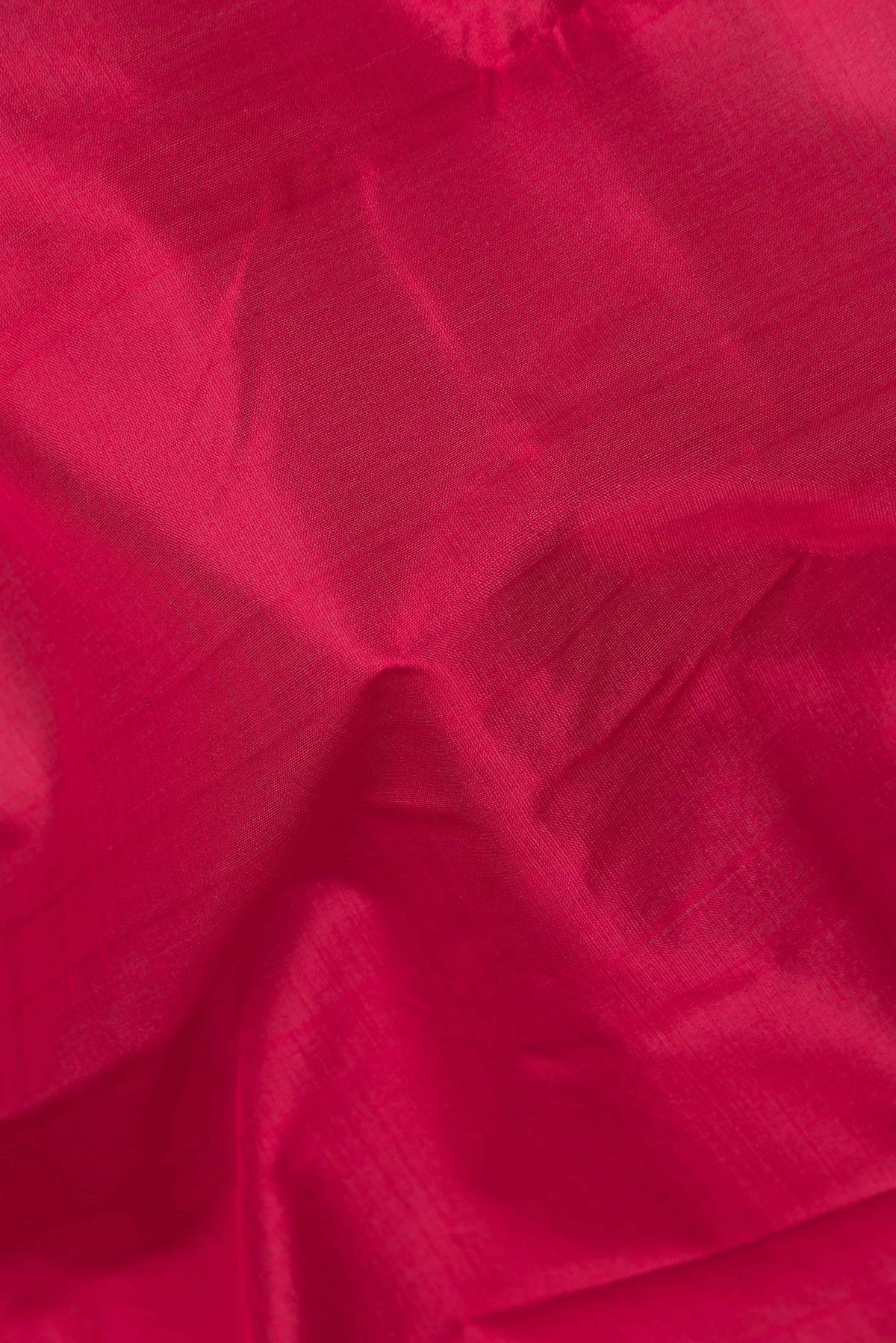 Close up of Pure Silk Red Kanjivaram Saree with Plain Body and Zari Border.  displaying folds