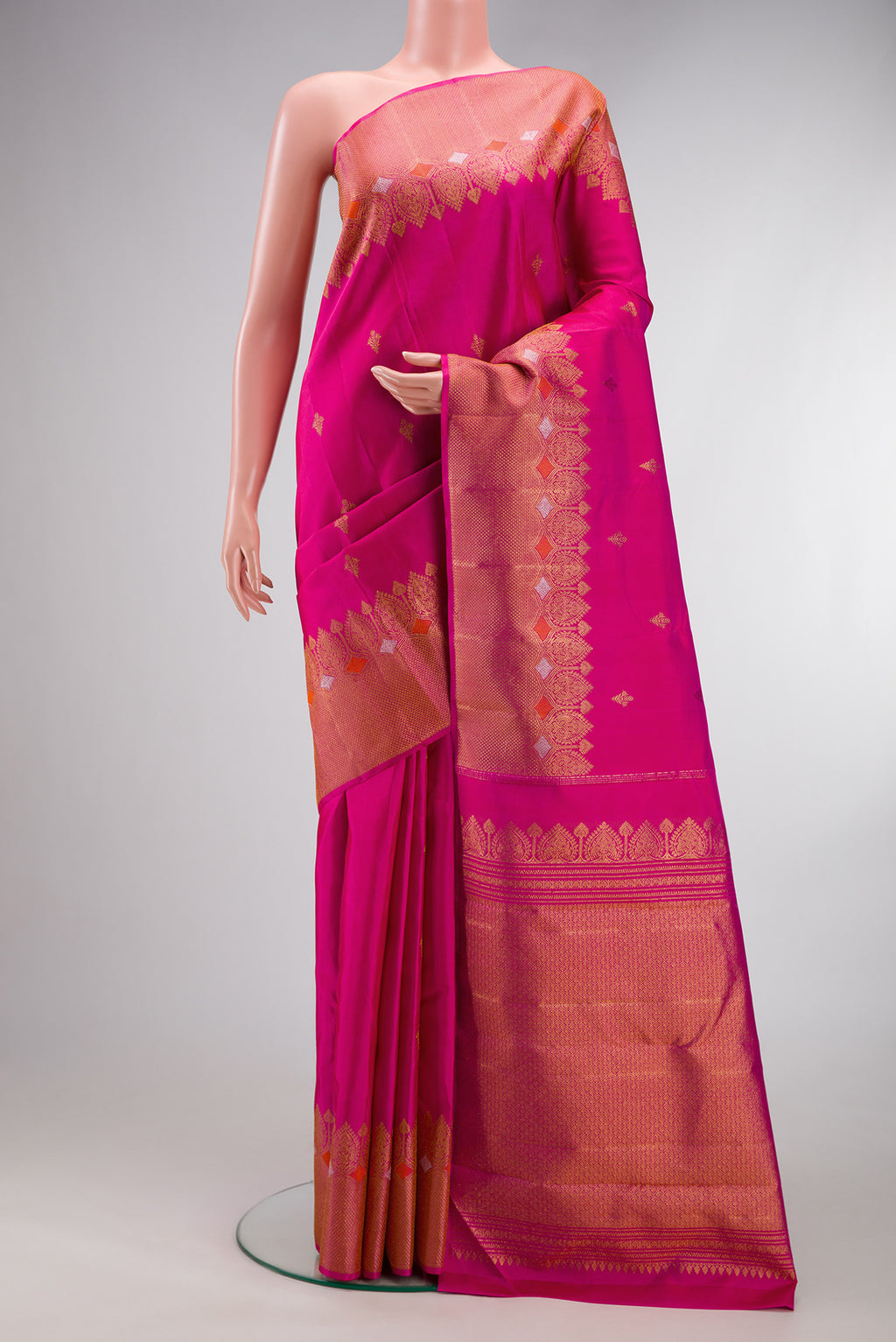 Dark Pink Kanjivaram Silk Saree with Zari Butta on the body and Fancy Border.  displayed on a mannequin