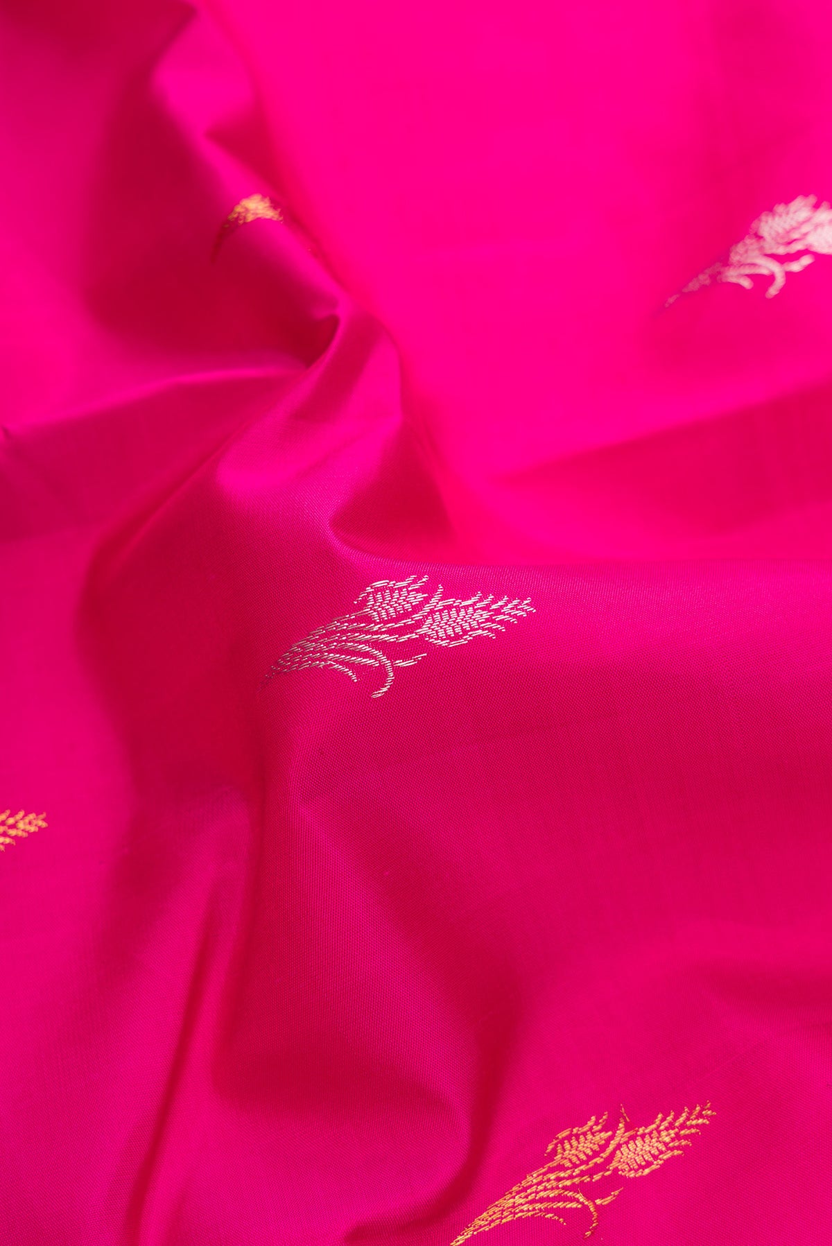 Close up of Pure Silk Dark Pink Kanjivaram Saree with Zari Butta on the body and Without Border.  displaying folds