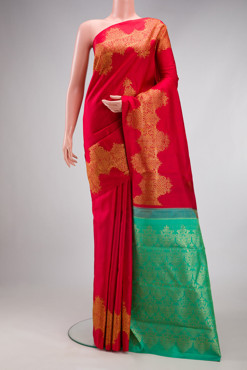Red Kanjivaram Silk Saree with Zari Butta on the body and Fancy Border.  displayed on a mannequin