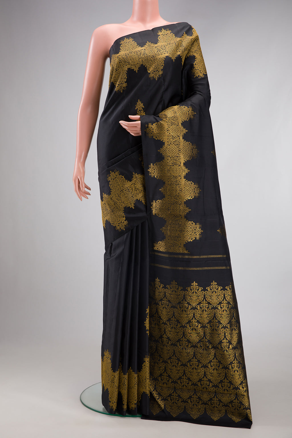 Black Kanjivaram Silk Saree with Zari Butta on the body and Fancy Border.  displayed on a mannequin