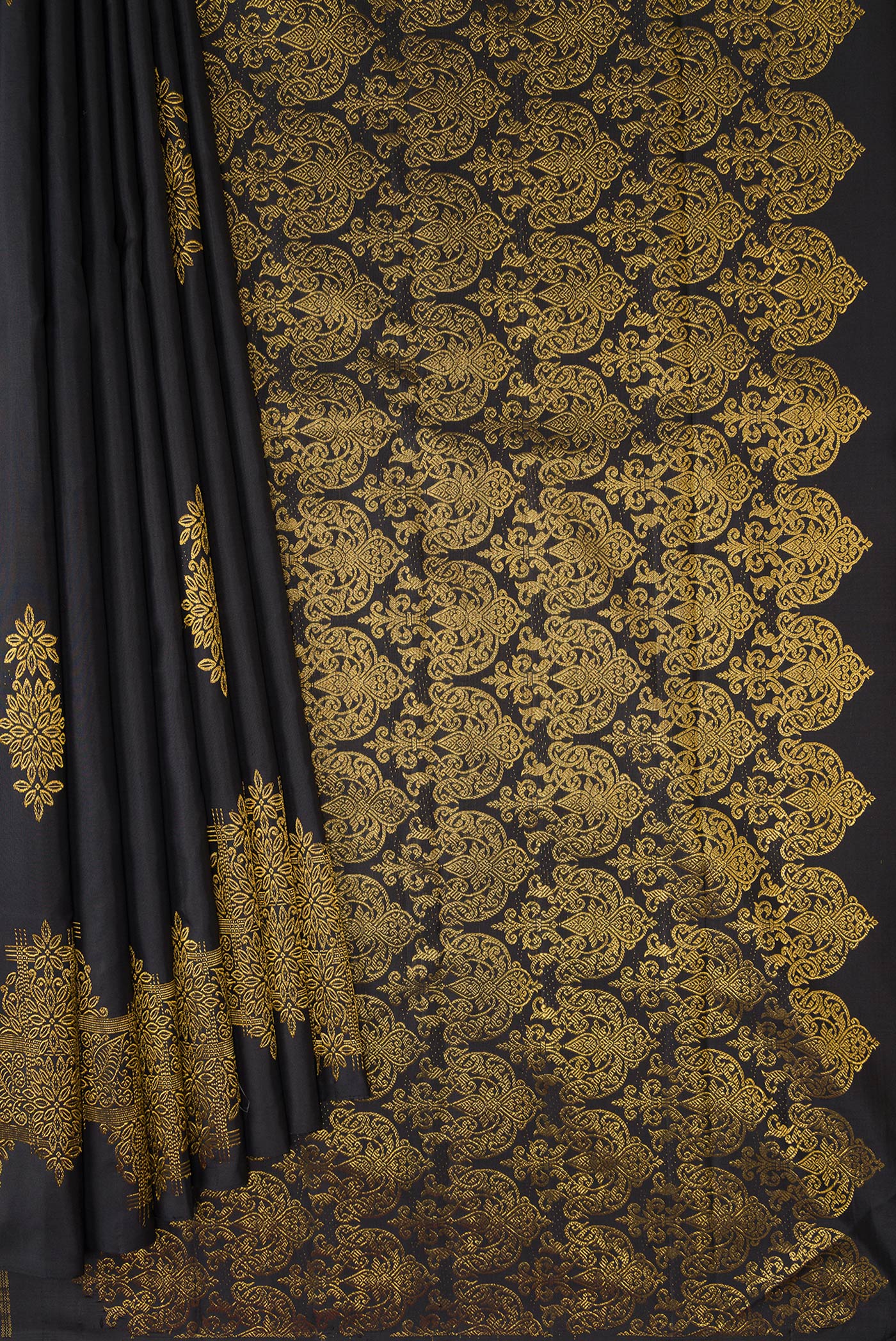 Pleats and pallu of Black Kanjivaram Silk Saree with Zari Butta on the body and Fancy Border. 