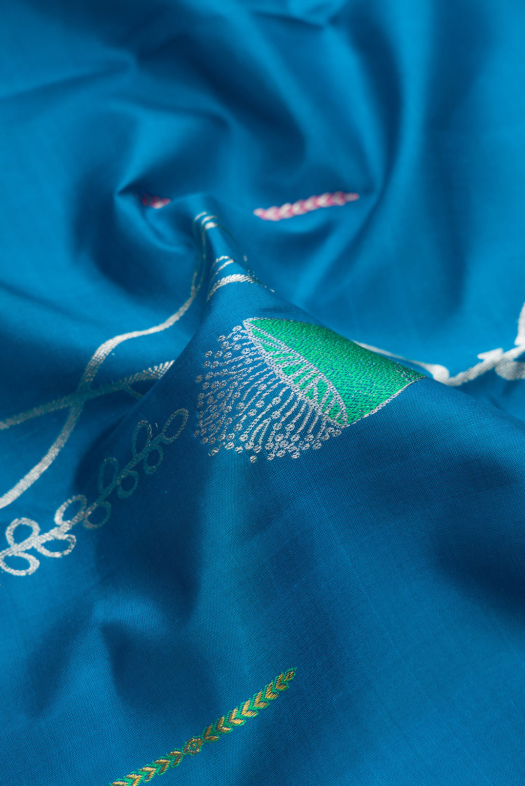 Close up of Pure Silk Peacock Blue Kanjivaram Saree with Zari Butta on the body and Without Border.  displaying folds