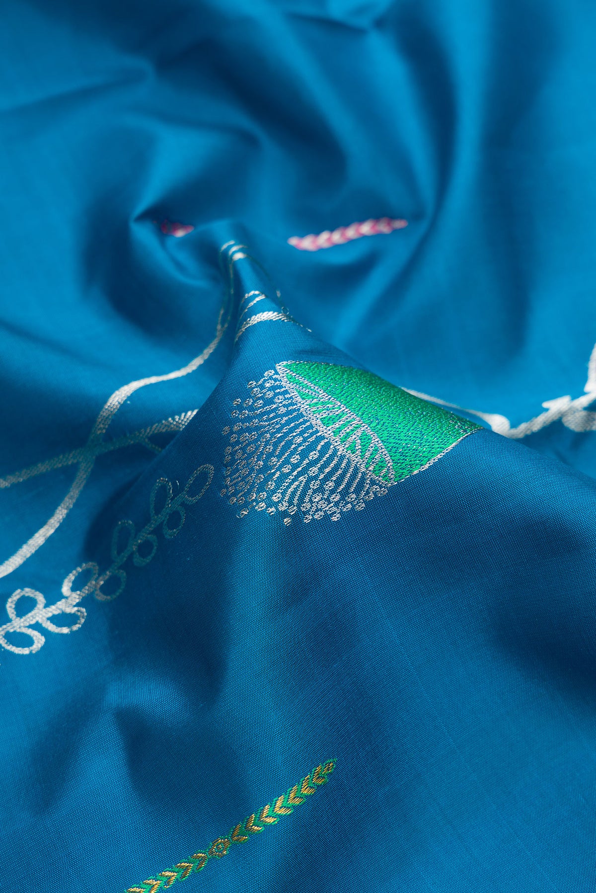 Close up of Pure Silk Peacock Blue Kanjivaram Saree with Zari Butta on the body and Without Border.  displaying folds