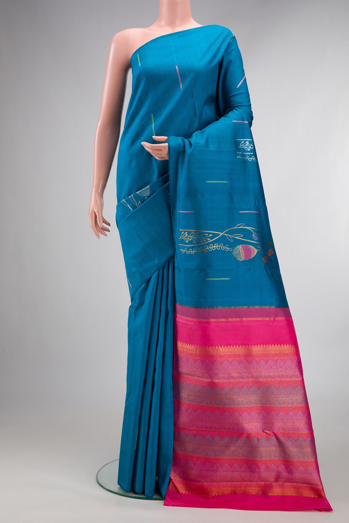 Pure Silk Peacock Blue Kanjivaram Saree with Zari Butta on the body and Without Border.  displayed on a mannequin