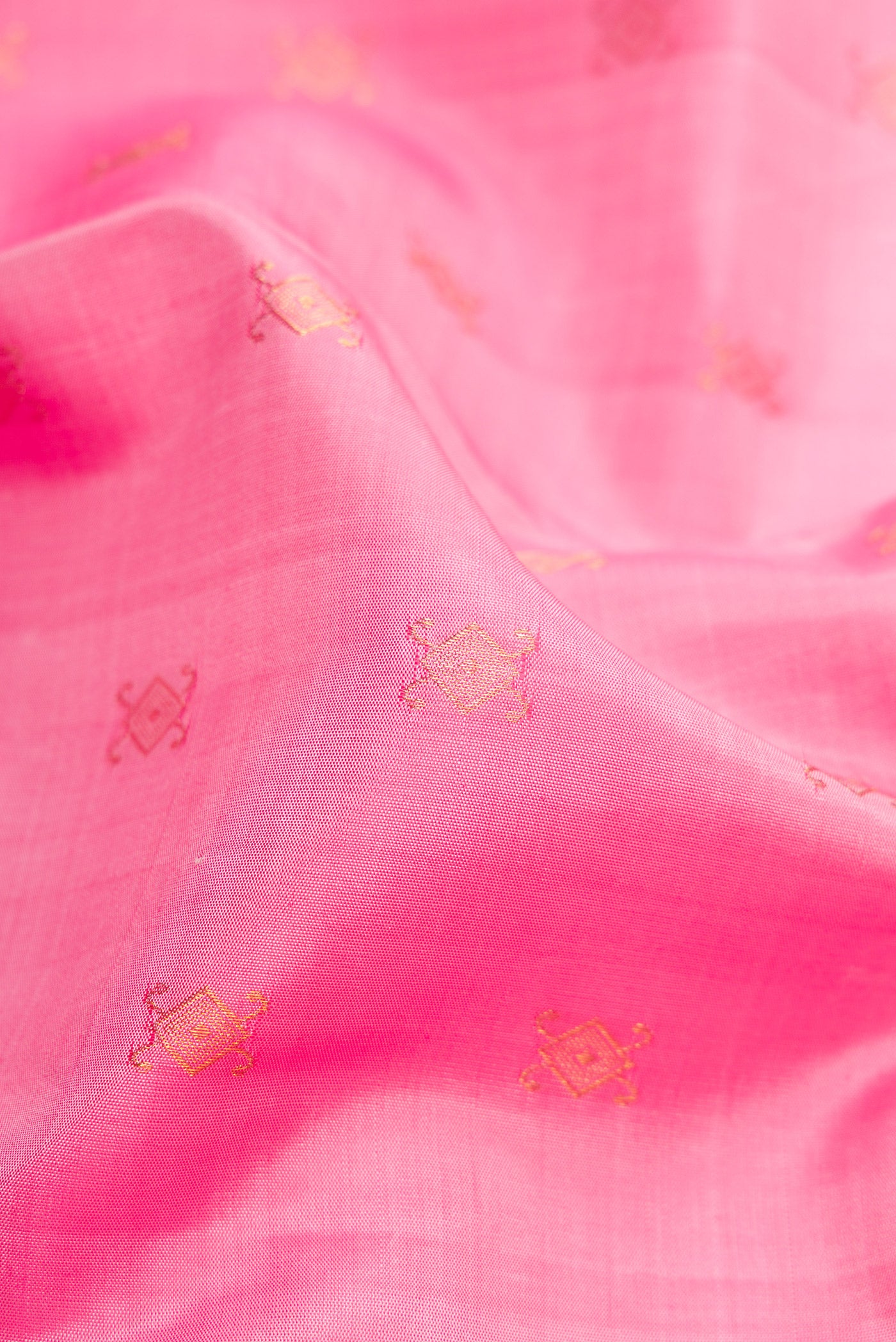 Close up of Pink Kanjivaram Silk Saree with Zari Butta on the body and Zari Border.  displaying folds