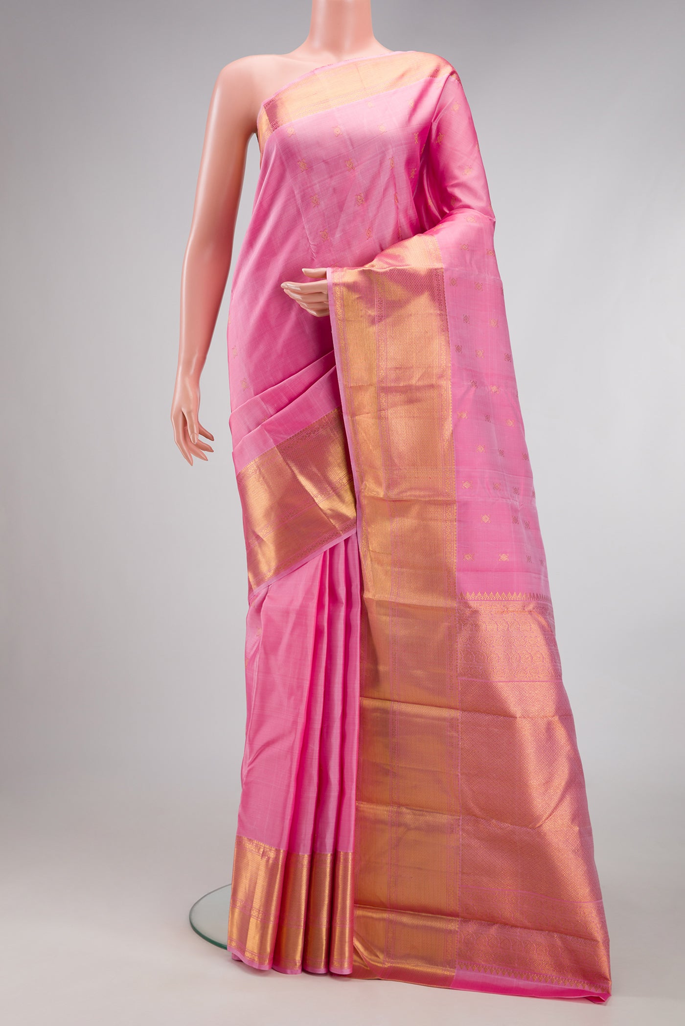 Pink Kanjivaram Silk Saree with Zari Butta on the body and Zari Border.  displayed on a mannequin