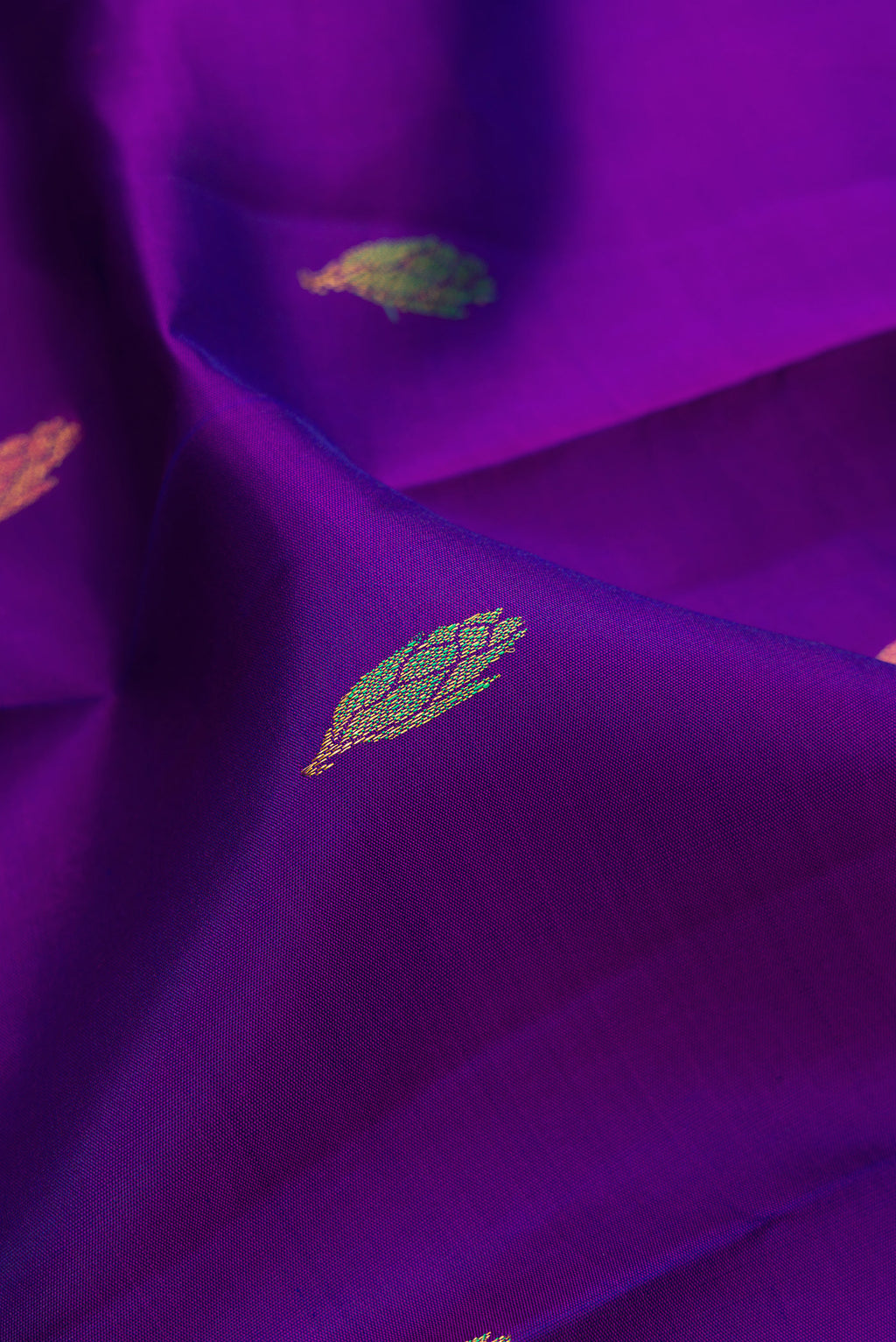Close up of Violet Kanjivaram Silk Saree with Zari And Thread Butta on the body and Without Border.  displaying folds