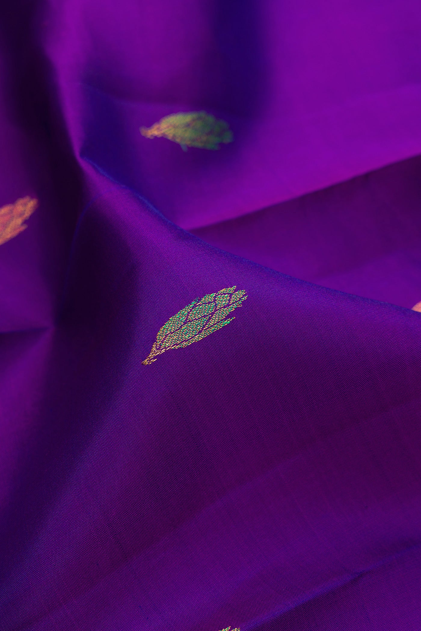 Close up of Violet Kanjivaram Silk Saree with Zari And Thread Butta on the body and Without Border.  displaying folds