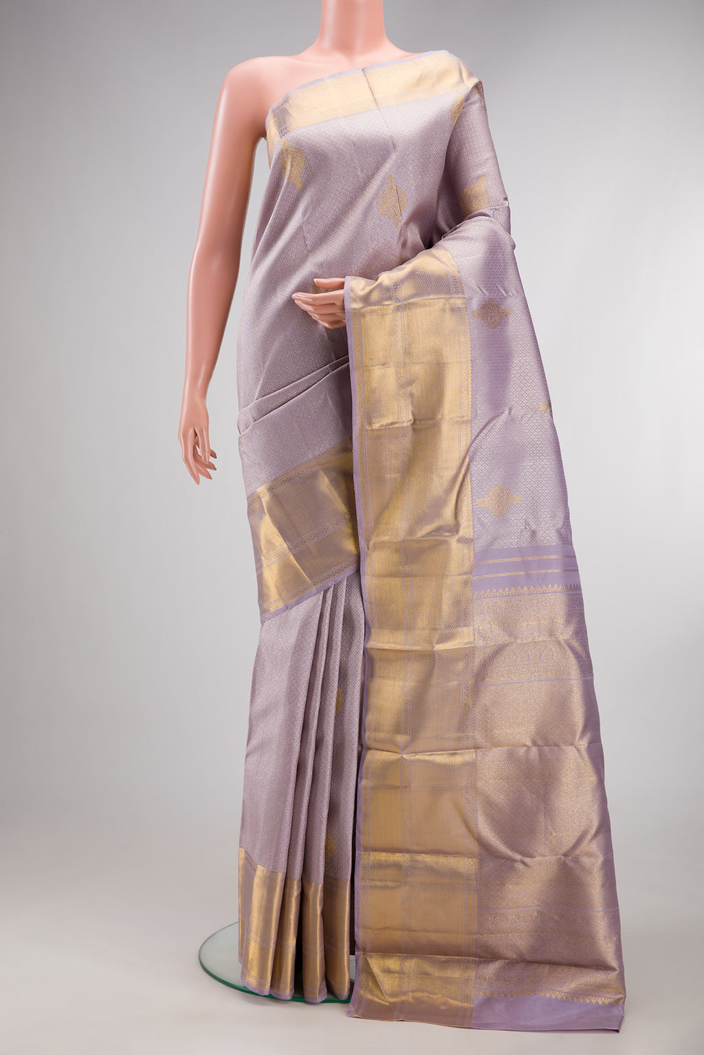 Pure Silk Lavender Kanjivaram Saree with Zari Brocade on the body and Zari Border.  displayed on a mannequin