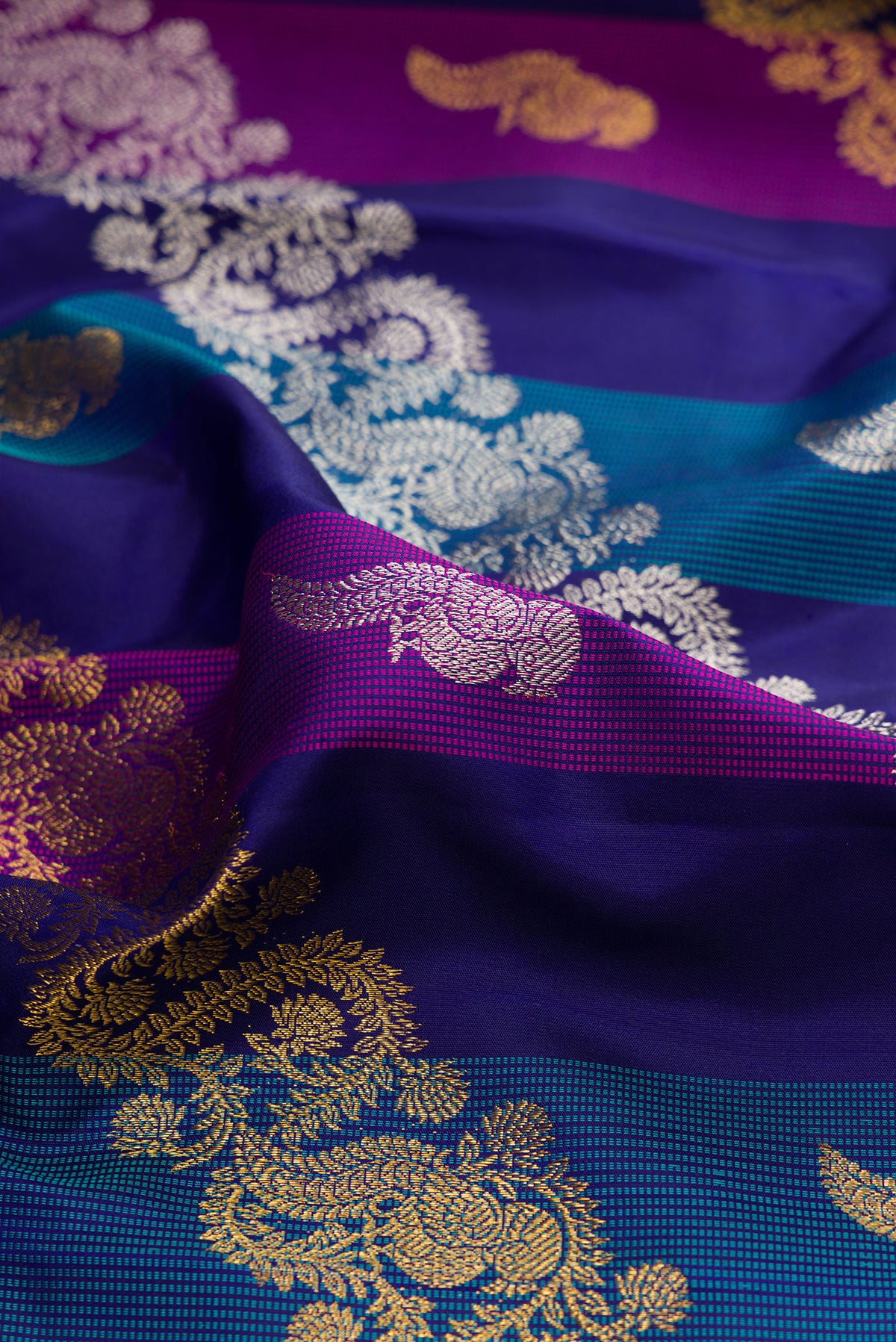 Close up of Multi Color Kanchipuram Silk Saree with Zari Brocade on the body and Zari Border.  displaying folds