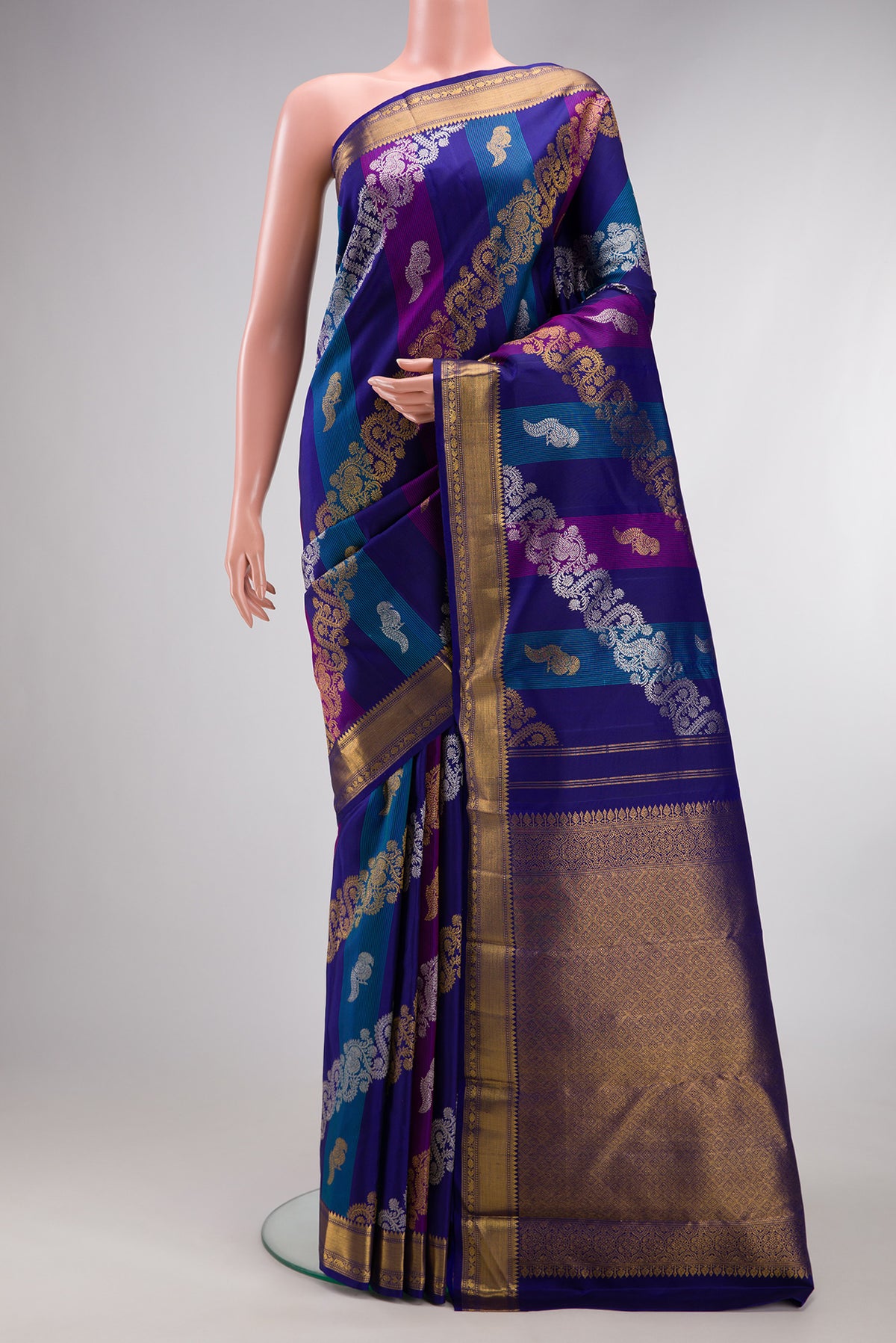 Multi Color Kanchipuram Silk Saree with Zari Brocade on the body and Zari Border.  displayed on a mannequin