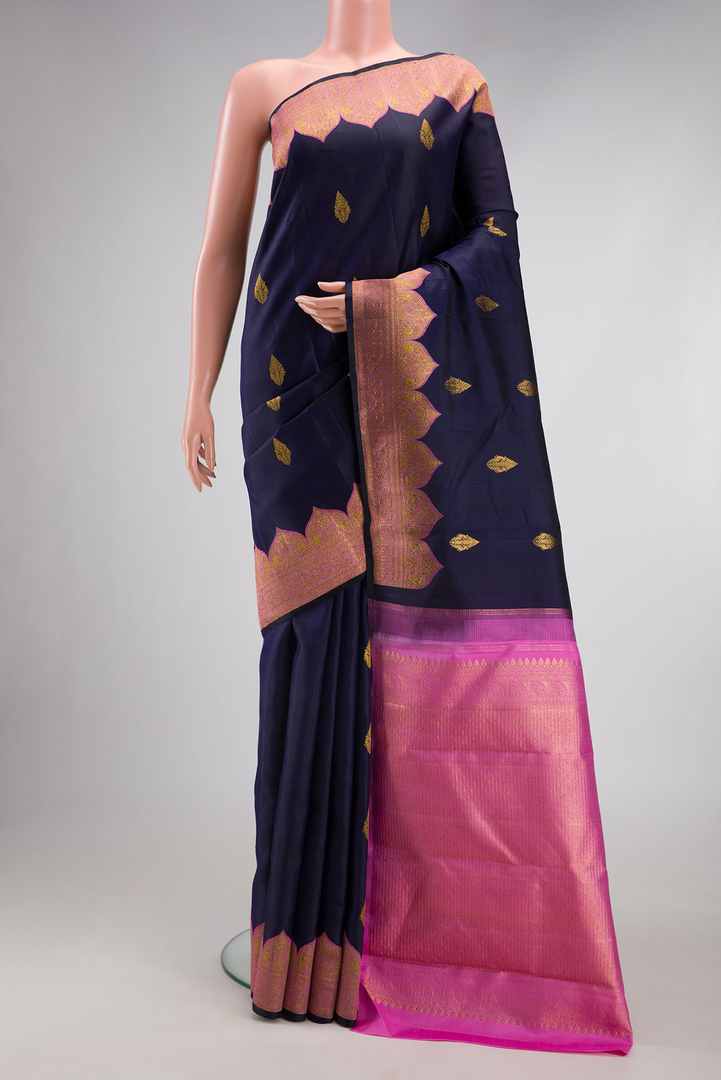 Navy Blue Kanjivaram Silk Saree with Zari Butta on the body and Fancy Border.  displayed on a mannequin