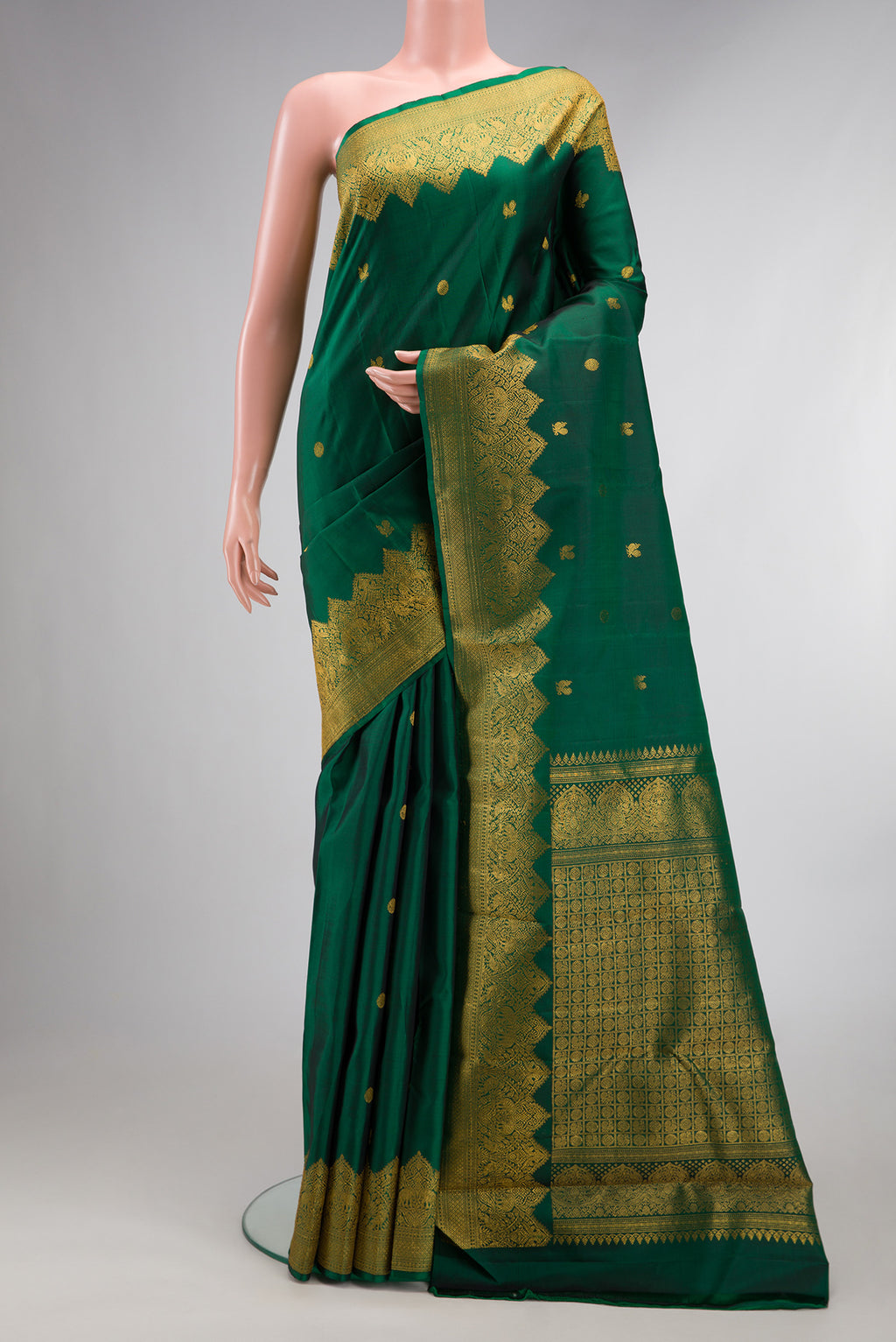 Pure Silk Bottle Green Dual Tone Kanjivaram Saree with Zari Butta on the body and Fancy Border.  displayed on a mannequin